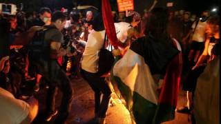 Protester catches on fire stamping out a burning American flag outside DNC