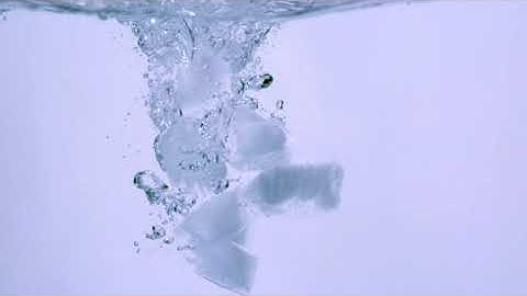 Ice cubes dropping into water (Slow Motion.)