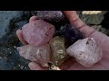 Treasure hunting in the wild rocky area found purple, yellow crystals and beryl, jade, gems