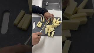 Chopping the mozzarella cheese for making cheese sticks