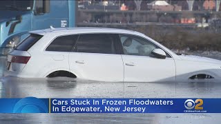 Cars remain stuck in frozen parking lot in Edgewater, N.J.