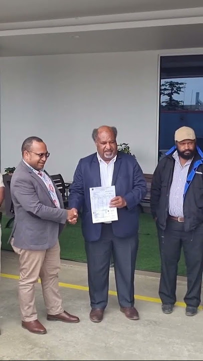 Hon. Wai Rapa presents a cheque of K1 million tax collection to IRC chairman Mr. Sam Koim