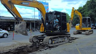 Pipe Line Digging With Mini Excavators Trucks On The Middle Of The Road