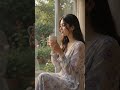 Woman sipping coffee looking outside