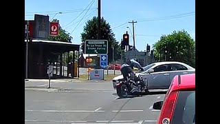 Motorcycle runs red light and crashes with a car