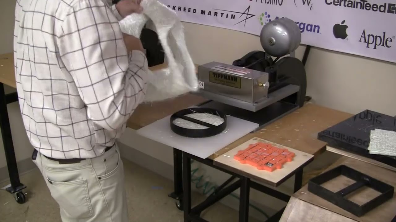 Die cutting several layers of fiberglass parts with a clicker die.