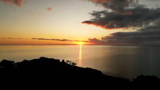 Drone video of the sunrise over Lake Malawi shoreline at Nkhotakota Pottery Lodge, Malawi