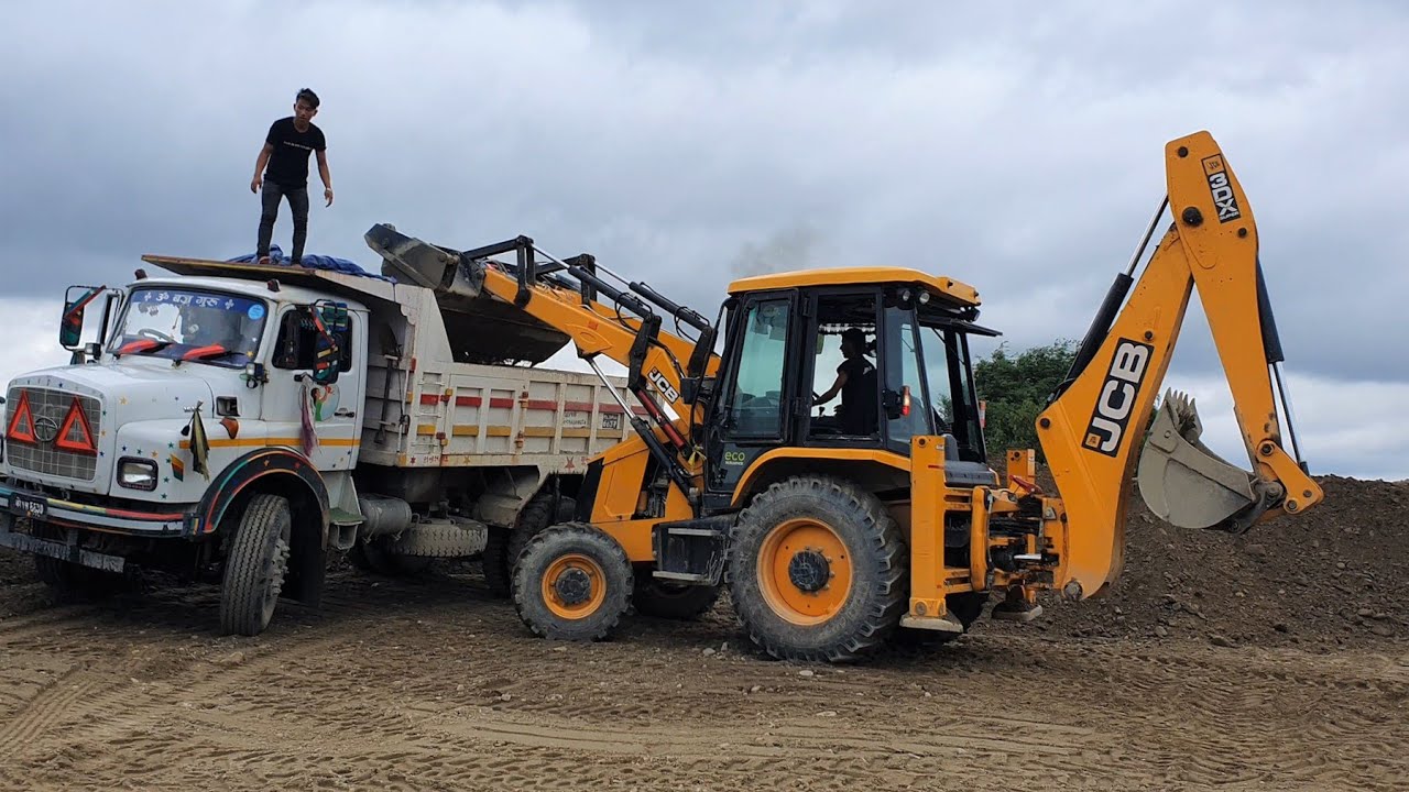 JCB Backhoe Machine Loading Gravel in Dump Truck - JCB Working on Sandy Place