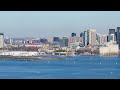 Aircraft landing at Billy Bishop Toronto City Airport , Lake Ontario and modern downtown skyline