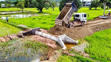 Push Soil Bury The  Sewer System In Water By Dozer And Clean The Soil On The Roadways with trucks 5t