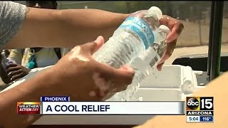Cold water, sunscreen handed out to keep people cool in intense heat.