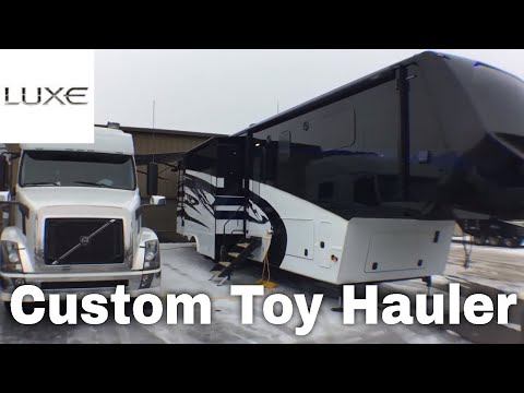 luxe-toy-hauler-luxury-fifth-wheel---pulling-with-volvo---smart-car-on-top