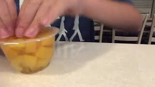 Opening a fruit cup without it spilling