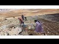 A woman with two children trying to build a shelter in the cold winter weather
