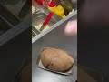 This is a potato that is being cut and ready to be served to consumers
