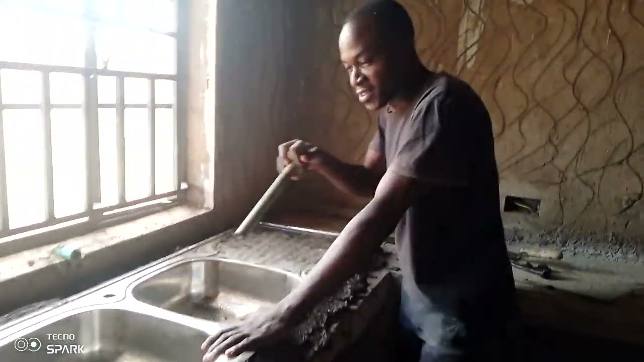 HOW TO INSTALL A KITCHEN SINK ON THE WORK TOP USING CEMENT MIX WITH SAND.