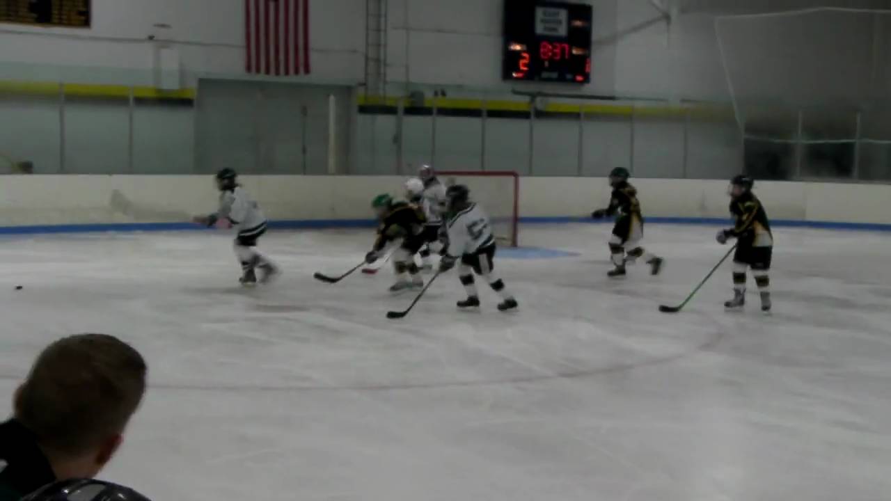 Hamden Girls Hockey player Emily Gotowala on the tip in against the Shoreline Sharks