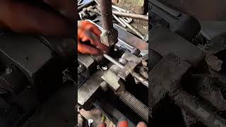 Operating a heavy metal thread rolling machine for industrial bolt fabrication steel outdoors