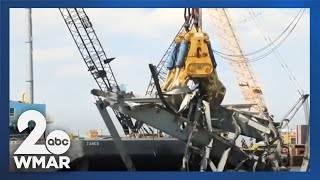 "Gus" and "Chessie" work to remove bridge wreckage from water