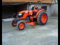 Neilo Kubota M7040 Tractor Grader in operation in restricted space