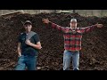 Family life father and son working together to spread compost on pasture