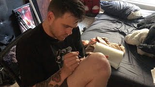 GIVING HIMSELF A TATTOO!!