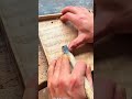 Using a curved gouge chisel tool to carve unique textured wavy patterns on a wooden tray surface