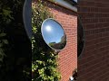 Mirror reflecting the sun light on to shaded area of the garden