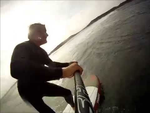Guy surfs in the Ocean attached to a pole and has a fun time!