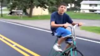 Boy riding bike down Mogadore Rd in Akron, OH