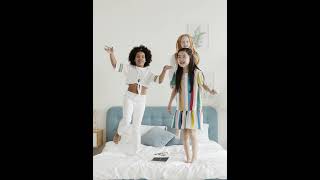 Funny Multi Ethnic Girls Jumping On The Bed