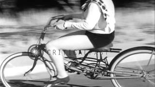 Young women ride bouncing bicycles aka 'Rhythm Bicycles' created by Joeseph Bell. HD Stock Footage