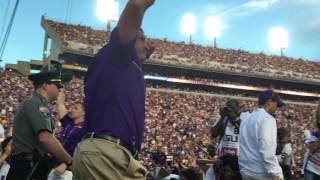 Ed Orgeron leads the LSU Tigers onto the field