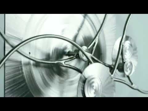 Cosmic Olives — kinetic metal wall sculpture by Kevin Duval