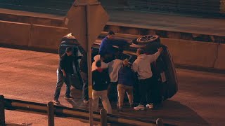 Driver in rollover crash assisted by group of people