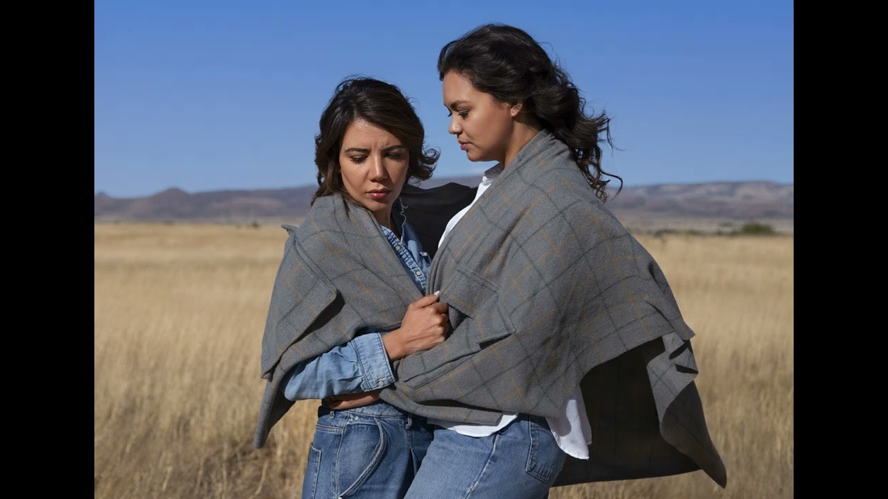 freepik  wide shot two women wrapped in a gray plaid shawl   73101