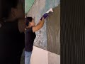 the process of installing large ceramic tiles on the walls in a room in a building #popular #shorts