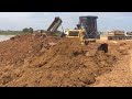 Construction machinery bulldozer and dump truck land fill operation