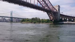 East River passing quickly under the Hell Gate Bridge