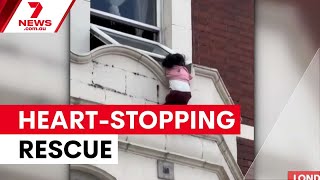 Child rescued after dangling from London window | 7NEWS
