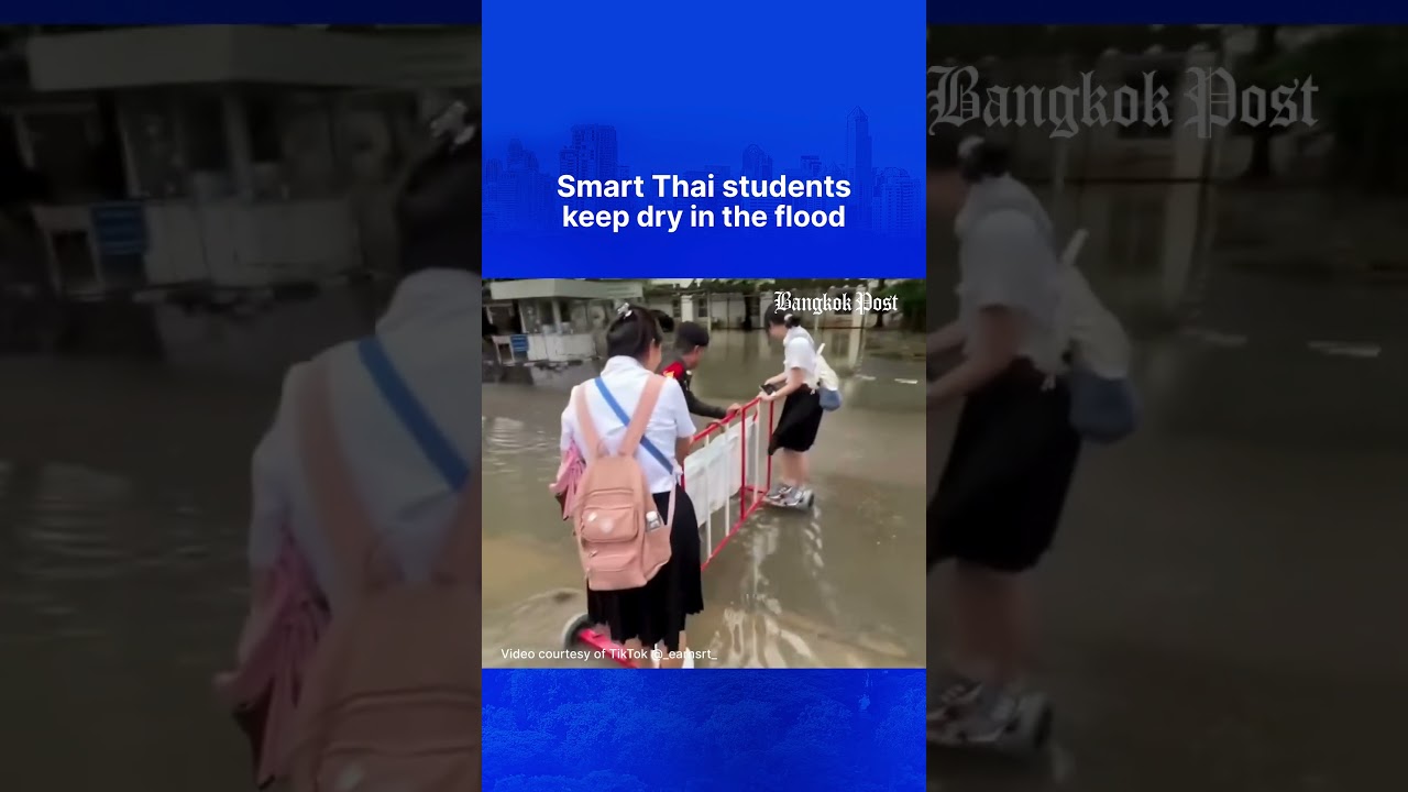 Smart Thai students keep dry in the flood