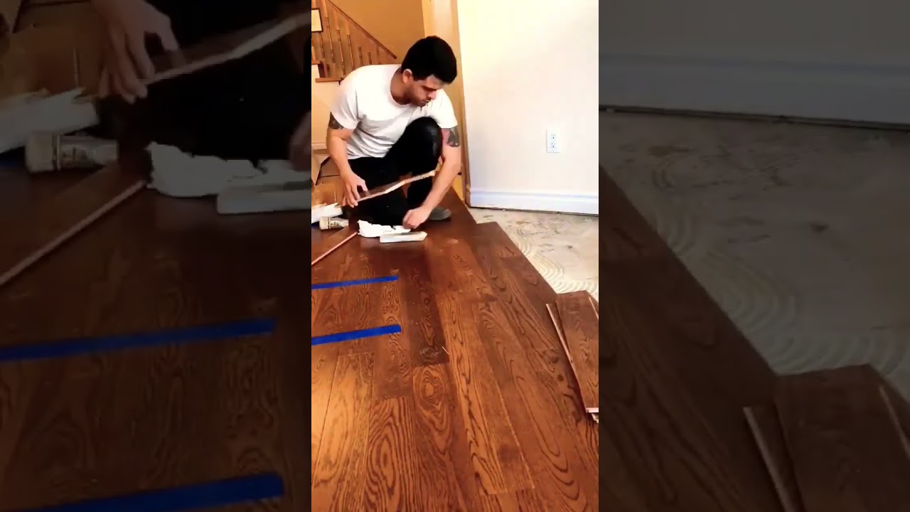 Finishing direct glue down installation of an engineered hardwood flooring in a townhouse in Toronto