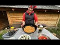 Highlanders prepare dinner in the village in the fresh air high in the mountains of ukraine