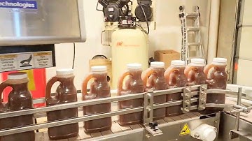 Complete Overflow Filler Bottling Line by No Limits Packaging Systems Corp.