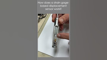 How does a strain gage-based displacement sensor work?