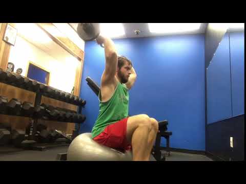 Swiss ball EZ bar overhead triceps extension