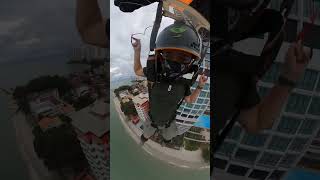 Base Jumper Jumps off a Building and Lands on a Shore