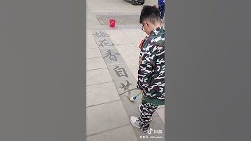 A boy demonstrated Chinese #calligraphy skills with an oversized brush at the roadside