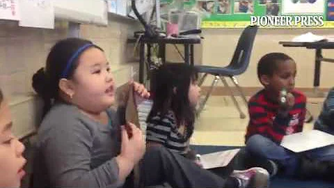 Monroe Elementary teacher Amy Hoff helps 1st grade...