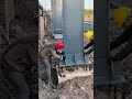 Two Workers Cooperate to Install a Massive Steel Column Base